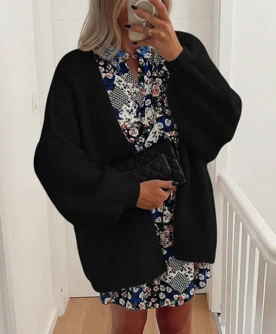 Model wearing a relaxed fit Comfy Oversized Cardigan over a floral dress, showcasing effortless style and cozy warmth.
